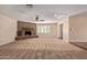 Spacious living room featuring a stone fireplace, hardwood flooring, and natural light at 645 S Esquire Way, Mesa, AZ 85202