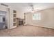 A large living room area featuring a fireplace, carpeted floors, and large windows at 645 S Esquire Way, Mesa, AZ 85202