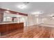 Open concept living room with wood floors and direct access to kitchen at 645 S Esquire Way, Mesa, AZ 85202