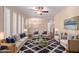 Comfortable living room with couches, chairs, ceiling fan, art and lots of natural light at 645 S Esquire Way, Mesa, AZ 85202