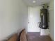 Utility room with a gray water heater and white walls and concrete flooring at 645 S Esquire Way, Mesa, AZ 85202