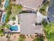 Overhead perspective of a private pool, cozy patio, and tiled roof in this Arizona home at 704 E Gemini Pl, Chandler, AZ 85249
