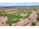 Aerial view of a well-manicured golf course with lush green fairways and serene water features at 704 E Gemini Pl, Chandler, AZ 85249