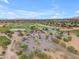A scenic aerial view of a lush golf course, clubhouse, and ample parking at the property at 704 E Gemini Pl, Chandler, AZ 85249