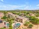 Aerial view showcasing the home's outdoor pool, patio, and lush landscaping in a suburban setting at 704 E Gemini Pl, Chandler, AZ 85249