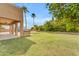 Lush backyard with well-maintained grass and a covered patio area at 704 E Gemini Pl, Chandler, AZ 85249