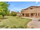 Manicured backyard featuring a covered patio and ample space for outdoor enjoyment at 704 E Gemini Pl, Chandler, AZ 85249