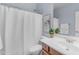 Cozy bathroom with a shower-tub combo, a plant, a painting, and a vanity with mirror at 704 E Gemini Pl, Chandler, AZ 85249