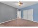 Spacious bedroom featuring blue accent wall, ceiling fan, and a closet with sliding doors at 704 E Gemini Pl, Chandler, AZ 85249