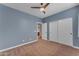Bedroom features carpeted floor, blue walls, and a closet with sliding doors at 704 E Gemini Pl, Chandler, AZ 85249