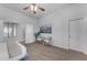 Well-lit bedroom with seating area, carpet flooring, and a door leading to other rooms at 704 E Gemini Pl, Chandler, AZ 85249