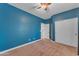 Bedroom with blue walls, sliding closet doors, carpet flooring, and neutral-colored trim at 704 E Gemini Pl, Chandler, AZ 85249