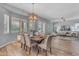 Elegant dining room with wood floors and a modern chandelier, perfect for Gathering gatherings at 704 E Gemini Pl, Chandler, AZ 85249