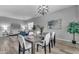 Elegant dining room featuring a modern chandelier, seating for six, and view into the living room at 704 E Gemini Pl, Chandler, AZ 85249