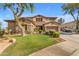 Inviting two-story home with a well-manicured lawn and mature trees, creating a serene and welcoming atmosphere at 704 E Gemini Pl, Chandler, AZ 85249