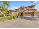 Charming two-story home with a three-car garage, stone accents, and well-maintained landscaping enhancing curb appeal at 704 E Gemini Pl, Chandler, AZ 85249