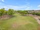 Spacious green lawn with mature trees offers a serene setting, perfect for outdoor activities and relaxation at 704 E Gemini Pl, Chandler, AZ 85249