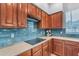 Modern kitchen with stainless steel appliances, dark cabinetry and sleek countertops at 704 E Gemini Pl, Chandler, AZ 85249