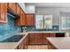 Well-appointed kitchen with modern appliances, bright countertops, and warm wood cabinets at 704 E Gemini Pl, Chandler, AZ 85249