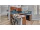 Well-lit kitchen with stainless appliances, central island with seating and modern countertops at 704 E Gemini Pl, Chandler, AZ 85249