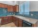 Kitchen features wood cabinets, a sleek white sink, and attractive blue tile backsplash at 704 E Gemini Pl, Chandler, AZ 85249