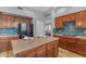 Bright kitchen with an island, breakfast bar, and stainless steel appliances, with living area view at 704 E Gemini Pl, Chandler, AZ 85249