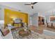 Open-concept living room with wood floors, a bright accent wall, and ample seating at 704 E Gemini Pl, Chandler, AZ 85249
