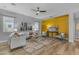 Inviting living room with wood floors, a ceiling fan, and a bright accent wall at 704 E Gemini Pl, Chandler, AZ 85249