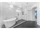 Elegant bathroom showcasing a soaking tub, glass shower, and modern herringbone tile at 704 E Gemini Pl, Chandler, AZ 85249