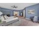 Bright main bedroom features contemporary décor, a ceiling fan, and an accent wall at 704 E Gemini Pl, Chandler, AZ 85249