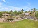 Well-maintained community entrance with lush landscaping, palm trees, and welcoming signage for visitors at 704 E Gemini Pl, Chandler, AZ 85249