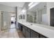 Spacious bathroom with a double vanity, lots of counterspace, tile floors, and mirrored closet doors at 7346 E Naranja Ave, Mesa, AZ 85209