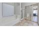 Bathroom with a soaking tub, separate glass shower, and mirrored closet doors at 7346 E Naranja Ave, Mesa, AZ 85209