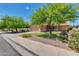 Lovely single-story home featuring desert landscaping, a well-manicured lawn, and mature shade trees at 7346 E Naranja Ave, Mesa, AZ 85209