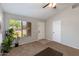 Bright living room featuring carpet flooring, a large window, and neutral color scheme at 7346 E Naranja Ave, Mesa, AZ 85209