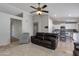 Open-concept living room and kitchen area featuring tile floors, ceiling fan and comfortable seating at 7346 E Naranja Ave, Mesa, AZ 85209