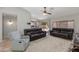 Open-concept living room and dining area featuring tile flooring and sliding doors to the patio at 7346 E Naranja Ave, Mesa, AZ 85209