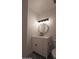 Updated bathroom featuring a stylish white vanity with black hardware and round mirror at 749 E Montebello Ave # 231, Phoenix, AZ 85014