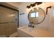 Modern bathroom featuring a glass-enclosed shower and stylish round mirror above the vanity at 749 E Montebello Ave # 231, Phoenix, AZ 85014
