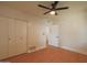 Comfortable bedroom features wood floors, a ceiling fan, and a large closet at 749 E Montebello Ave # 231, Phoenix, AZ 85014