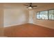 Well-lit living room boasts wood floors, ceiling fan, a white front door, and large windows at 749 E Montebello Ave # 231, Phoenix, AZ 85014