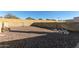 View of the spacious, rockscaped backyard with block wall at 7654 E Calypso Ave, Mesa, AZ 85208