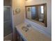 Bathroom featuring a tub shower and ornate framed mirror at 7654 E Calypso Ave, Mesa, AZ 85208