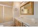 Bathroom featuring a tub shower and ornate framed mirror at 7654 E Calypso Ave, Mesa, AZ 85208