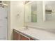 Bathroom with a tub shower, large mirror and neutral walls at 7654 E Calypso Ave, Mesa, AZ 85208