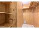 Walk-in closet with built in shelving and wood paneling at 7654 E Calypso Ave, Mesa, AZ 85208