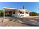 Charming home with covered carport and desert landscaping at 7654 E Calypso Ave, Mesa, AZ 85208