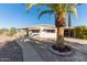 Charming home featuring mature landscaping, sidewalk, and attached carport at 7654 E Calypso Ave, Mesa, AZ 85208