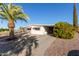 Charming home with covered carport and desert landscaping at 7654 E Calypso Ave, Mesa, AZ 85208