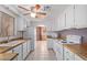 Bright kitchen featuring white cabinets, wood counters, an arched opening and ample natural light at 7654 E Calypso Ave, Mesa, AZ 85208